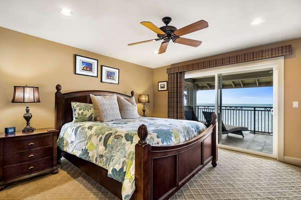 The main suite with a King bed and twin nightstands, by a sliding glass door to the private lanai.