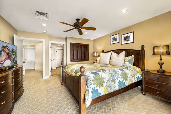 Main suite with King bed, flat-screen TV, dresser, and nightstands.