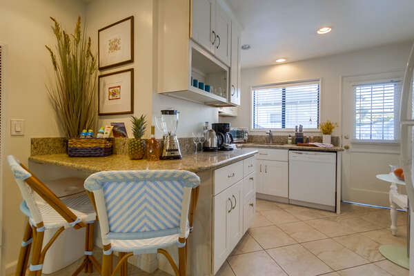 Breakfast Bar Leading into Fully Stocked Kitchen in our Mission Beach Rental in San Diego