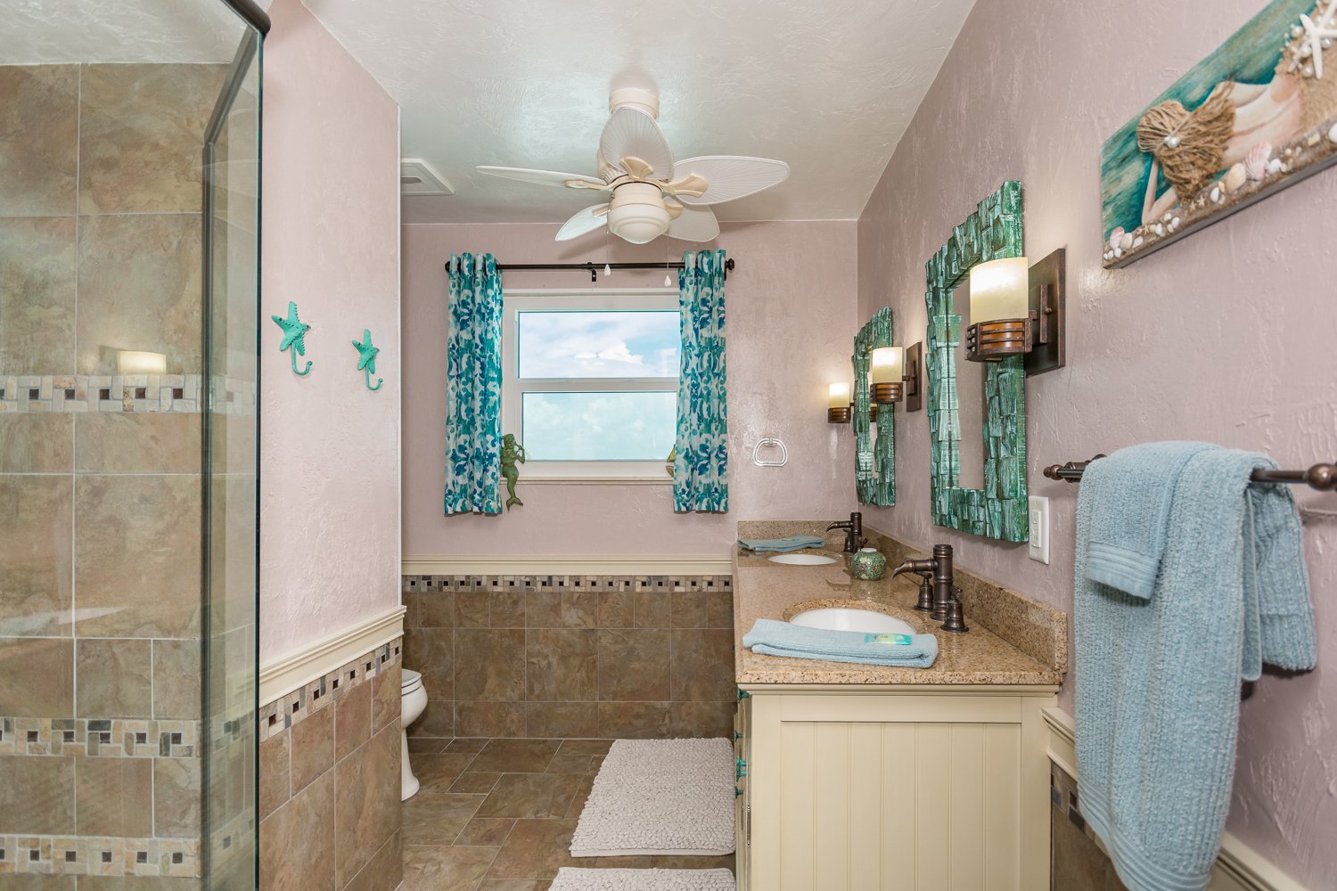 Bright and open master bathroom with double sink and walk-inshower.