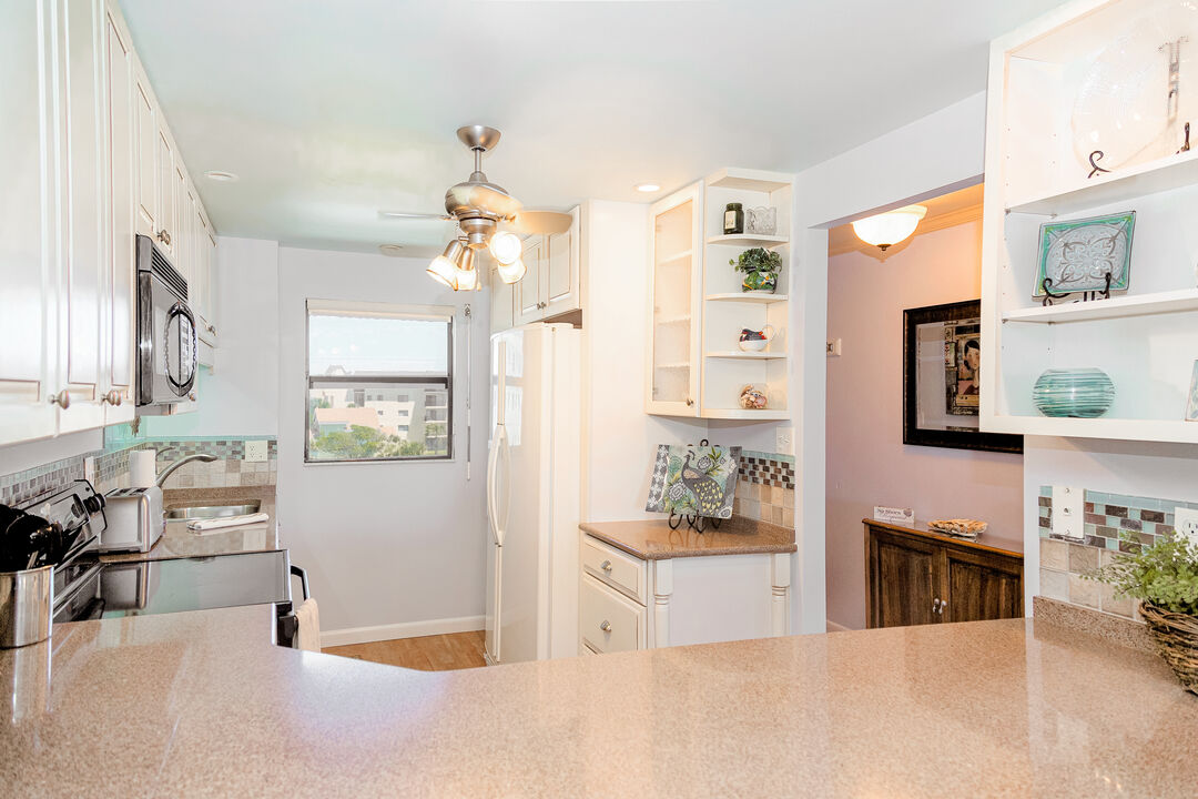 Bright and airy kitchen with coastal-inspired decor and modern appliances.