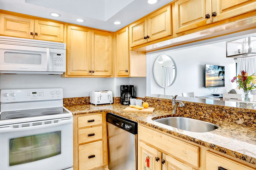 Fully equipped kitchen with wooden cabinetry and granite countertops