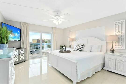 Peaceful master bedroom with King memory foam mattress, flatscreen TV and walkout to your private balcony