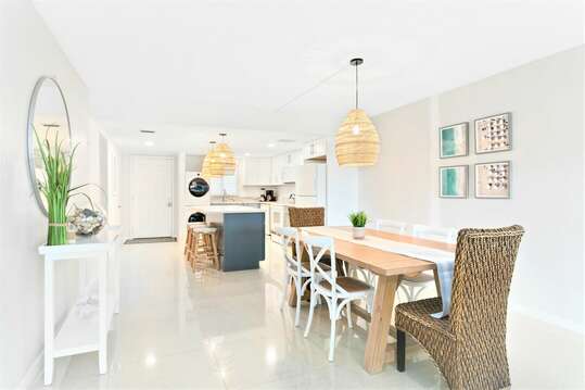 Open concept dining room and kitchen with breezy coastal vibe