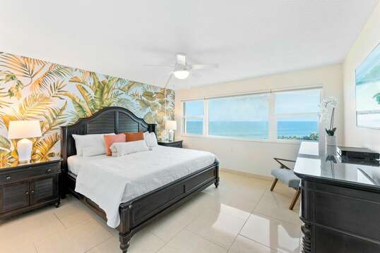 Tropical master bedroom with a beautiful view of the ocean from your King bed. There is also a closet and flatscreen TV for your convenience