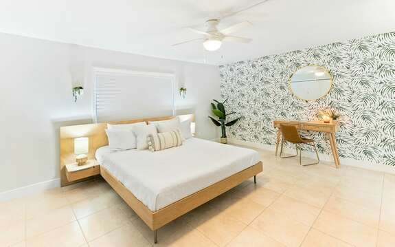 Spacious tropical inspired Master Bedroom with King Bed, Large flatscreen Smart TV, desk, closet & ensuite