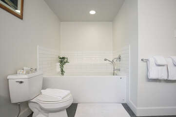 Primary ensuite w/  double vanity, soaker tub, and walk-in shower