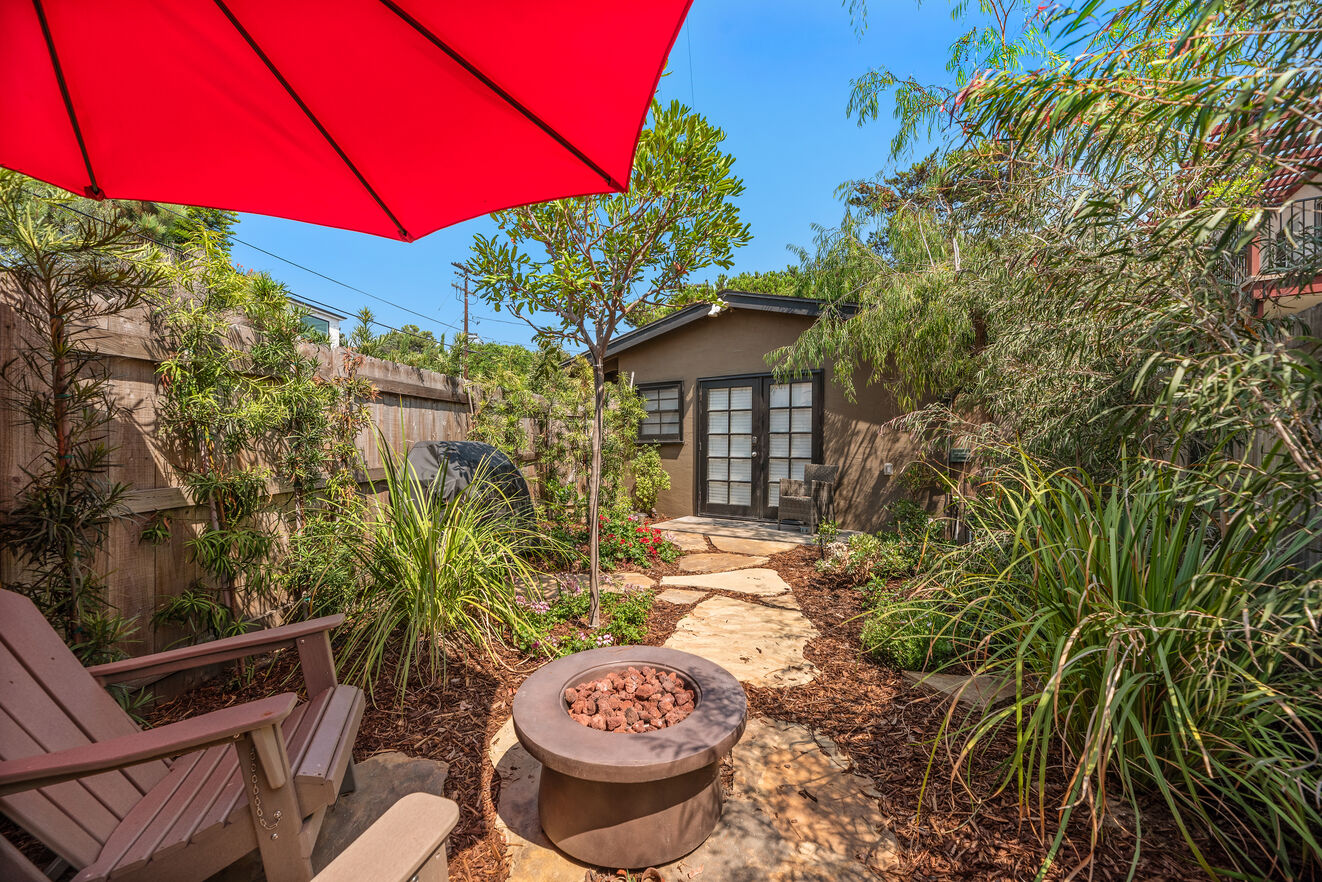 The newly re-landscaped back yard with BBQ, fire pit and sitting area is a beautiful area to relax outside.