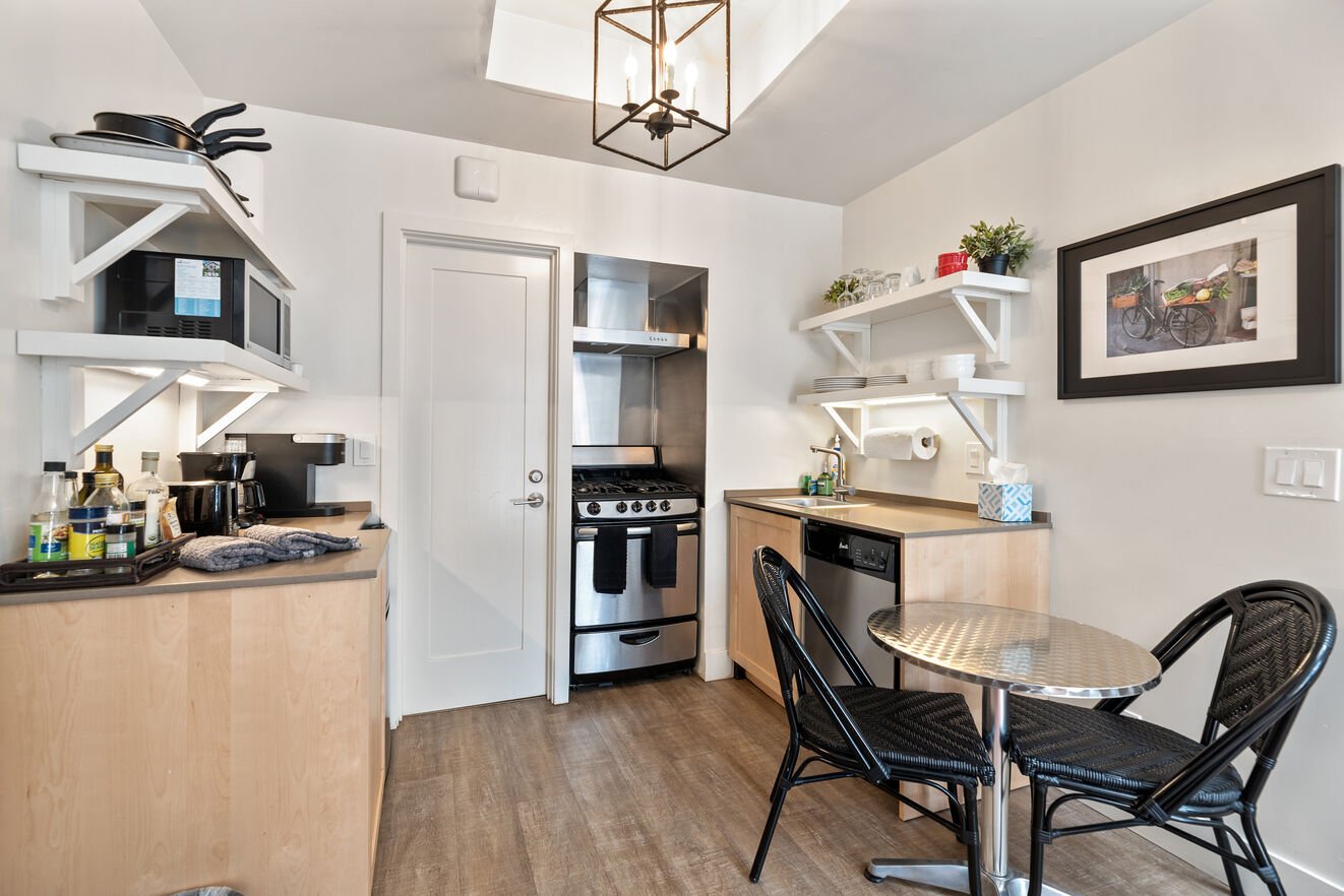 Dining area for 2, small but efficient kitchen with dishwasher, refrigerator, microwave, gas oven and range, keurig coffee and regular drip coffee makers.