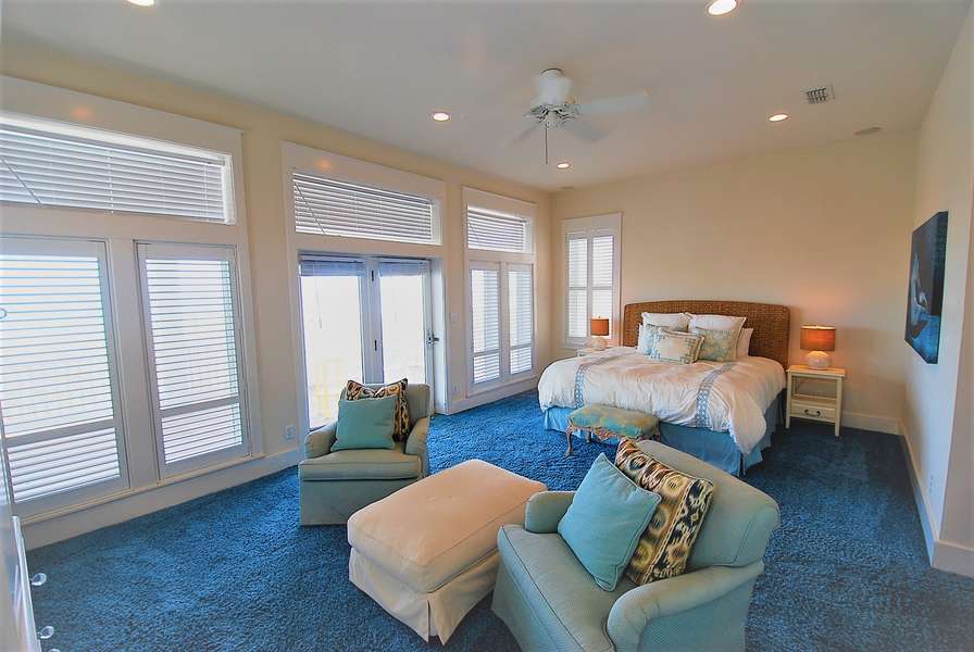 Master Bedroom with windows overlooking private balcony to beach
