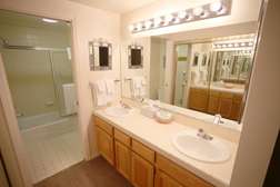 Master bath has double sinks, tub/shower combo and toilet