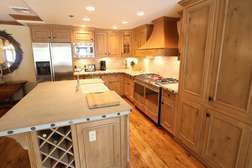 Kitchen with island, 6 burner gas stove, & stainless steel appliances
