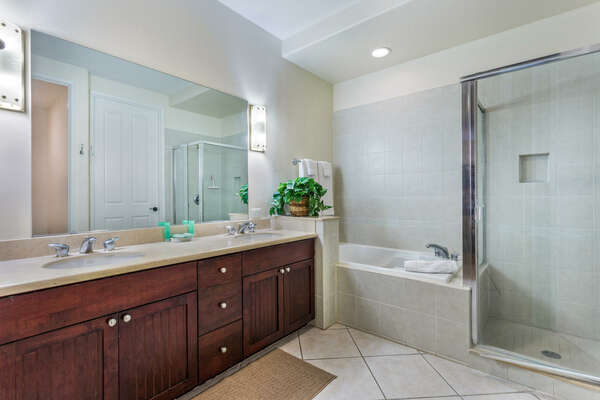 Bathroom with His/Hers Vanity, Walk-in Shower, and Bathtub
