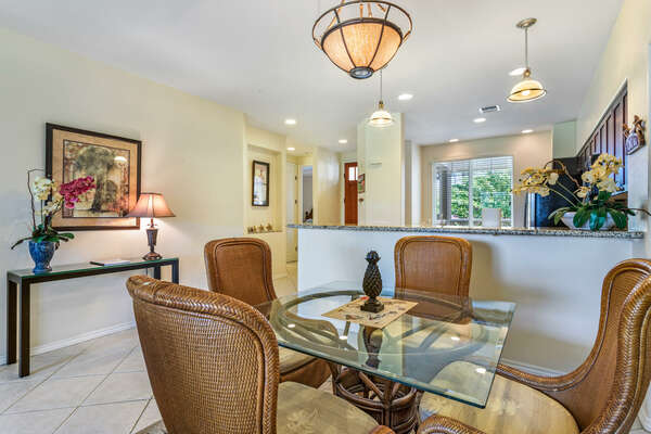 Dining Area with Glass Table and Comfortable Chairs at Waikoloa Hawai'i Vacation Rentals