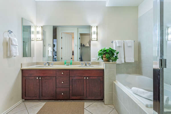 Bathroom with Bathtub, Walk-in Shower, and Vanity with Wooden Cabinets