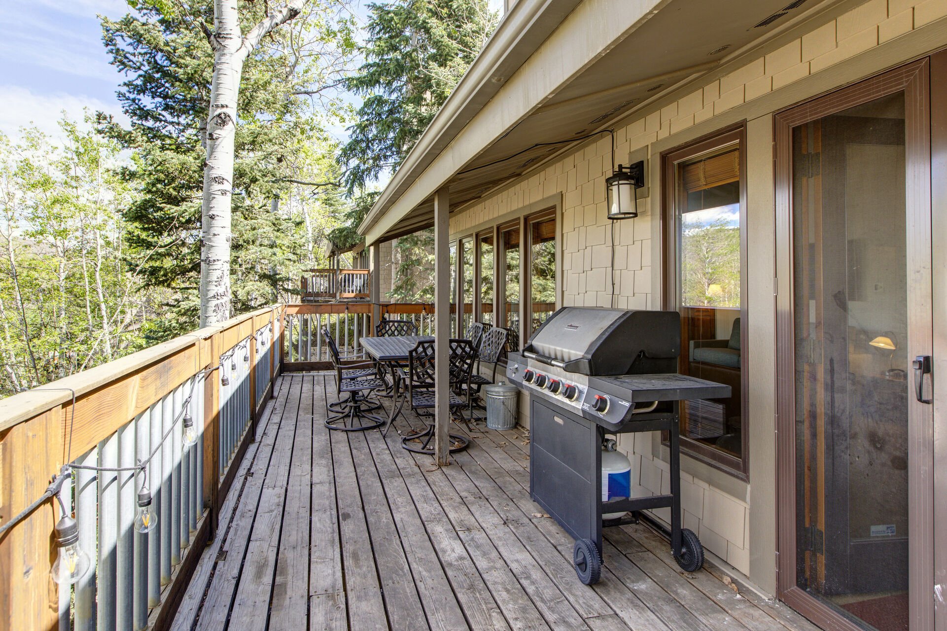 Private wrap around deck with BBQ, outdoor seating, and hot tub