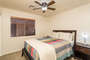 Third Bedroom also features a ceiling fan and a bedside lamp