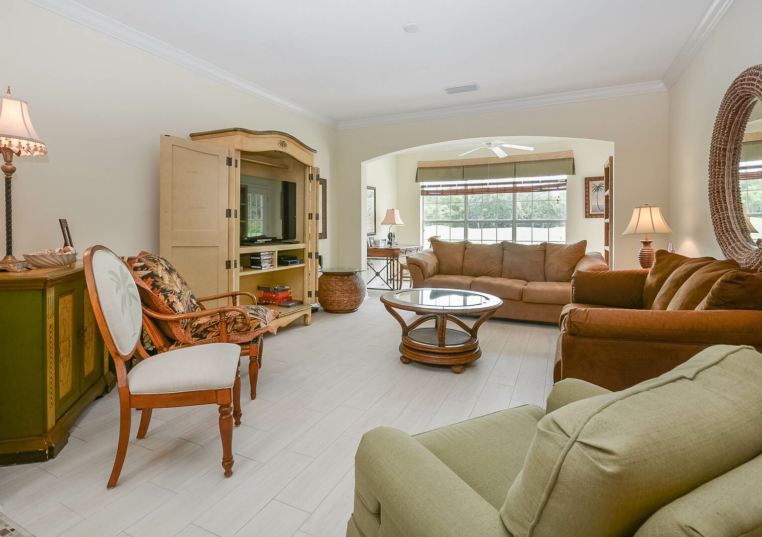 The spacious living area of this new Smyrna beach Florida vacation home with ample seating and large TV.