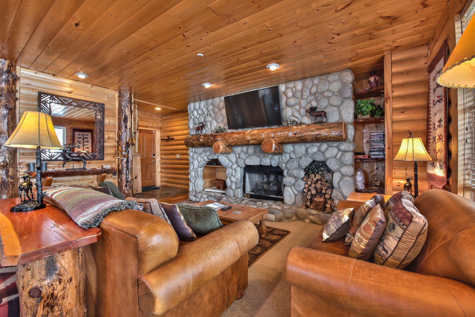 Living Room with Comfortable Mountain Furnishings, a Queen Sleeper Sofa, Stone Fireplace, Flat Screen TV and Mountain Views