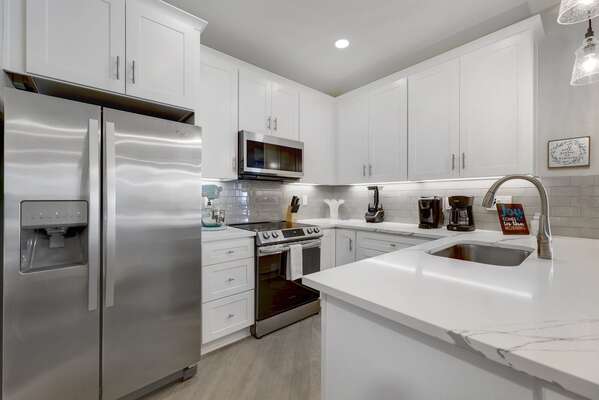 Beautiful kitchen with quartz countertop- fully equipped for all of your baking and cooking needs!