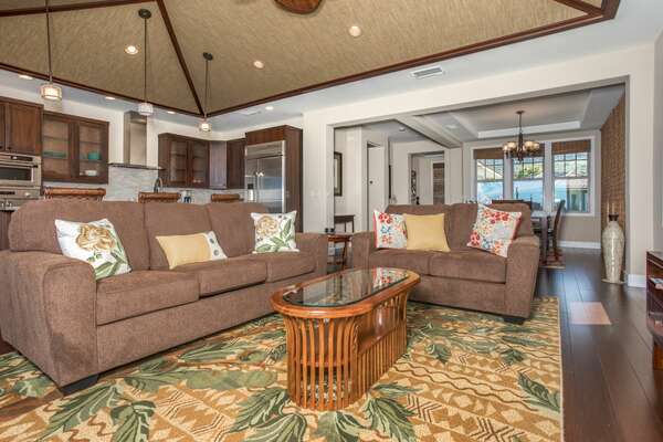 Comfortable Living Area with plush couches and glass-topped coffee table.