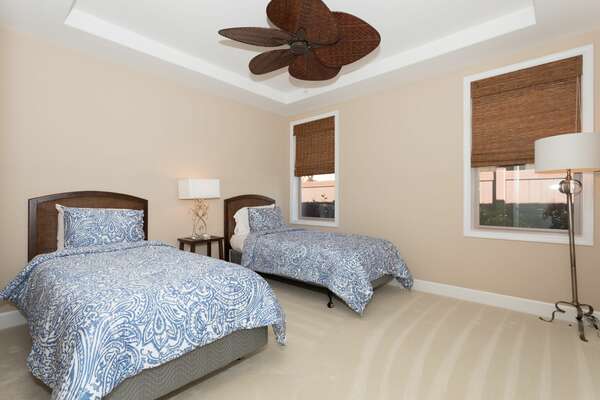 Bedroom 3 with two beds separated by a nightstand, and an ornate ceiling fan.