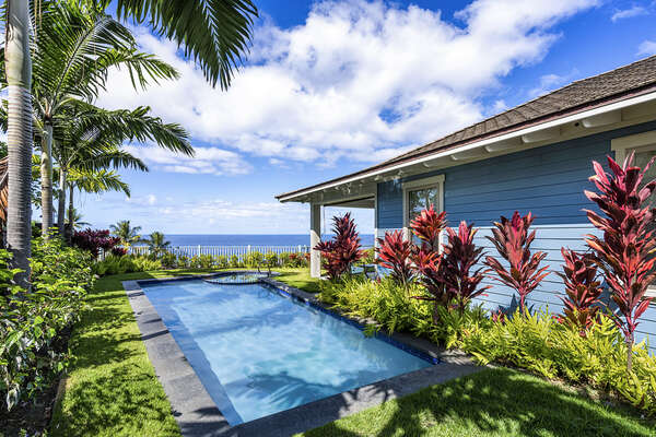 Bright tropical landscaping surrounding the backyard pool of this Kona Hawai'i vacation rental.