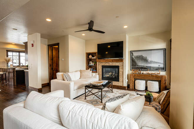 Main level living room with comfortable furnishings and smart TV