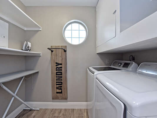 Laundry room in condo! You will also find tennis racquets and balls to enjoy a game of tennis.