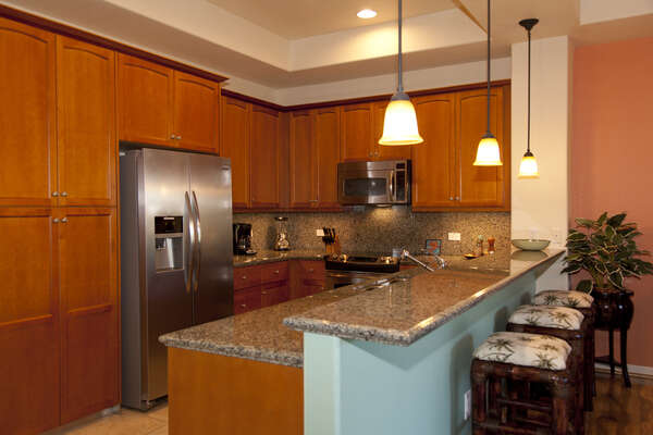 Kitchen with Breakfast Bar, Refrigerator, and Microwave