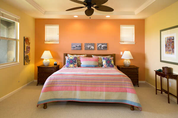 Bedroom with Large Bed< Nightstands, and Ceiling Fan