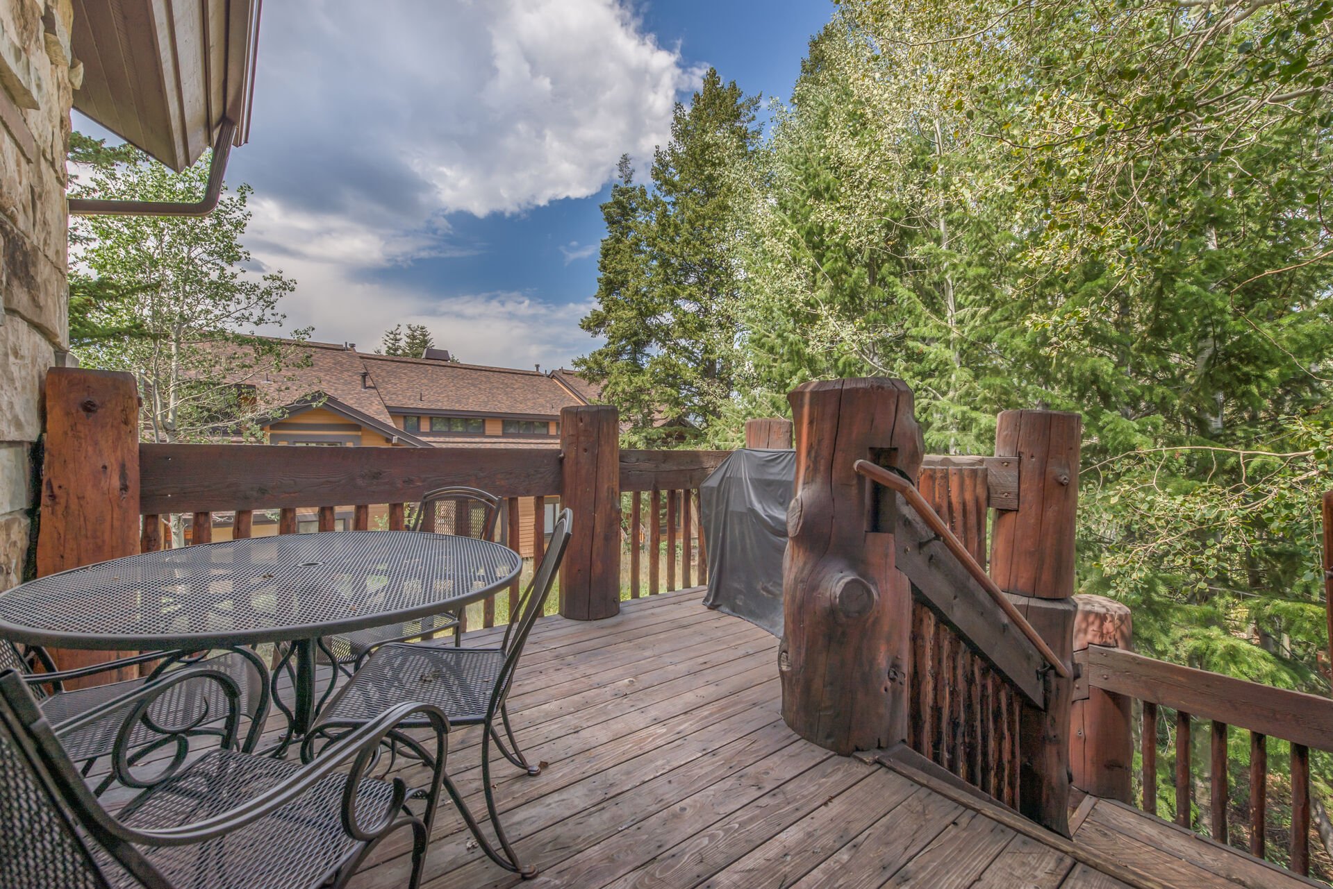 Upper Level Deck with BBQ Grill and Patio Seating - Stairs to Lower Level Deck with Private Hot Tub