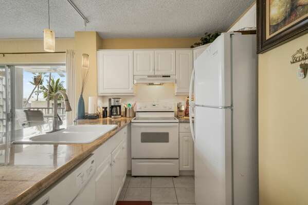 Fully Equipped Kitchen with oven, sink and fridge.