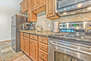 Equipped Kitchen with Granite Countertops, Stainless Steel Appliances and Bar Seating for 4