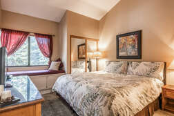 Master bedroom (downstairs) with King size bed, flat screen TV, and full master bath en-suite