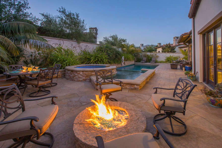 Stay warm by the outdoor firepit in the Backyard