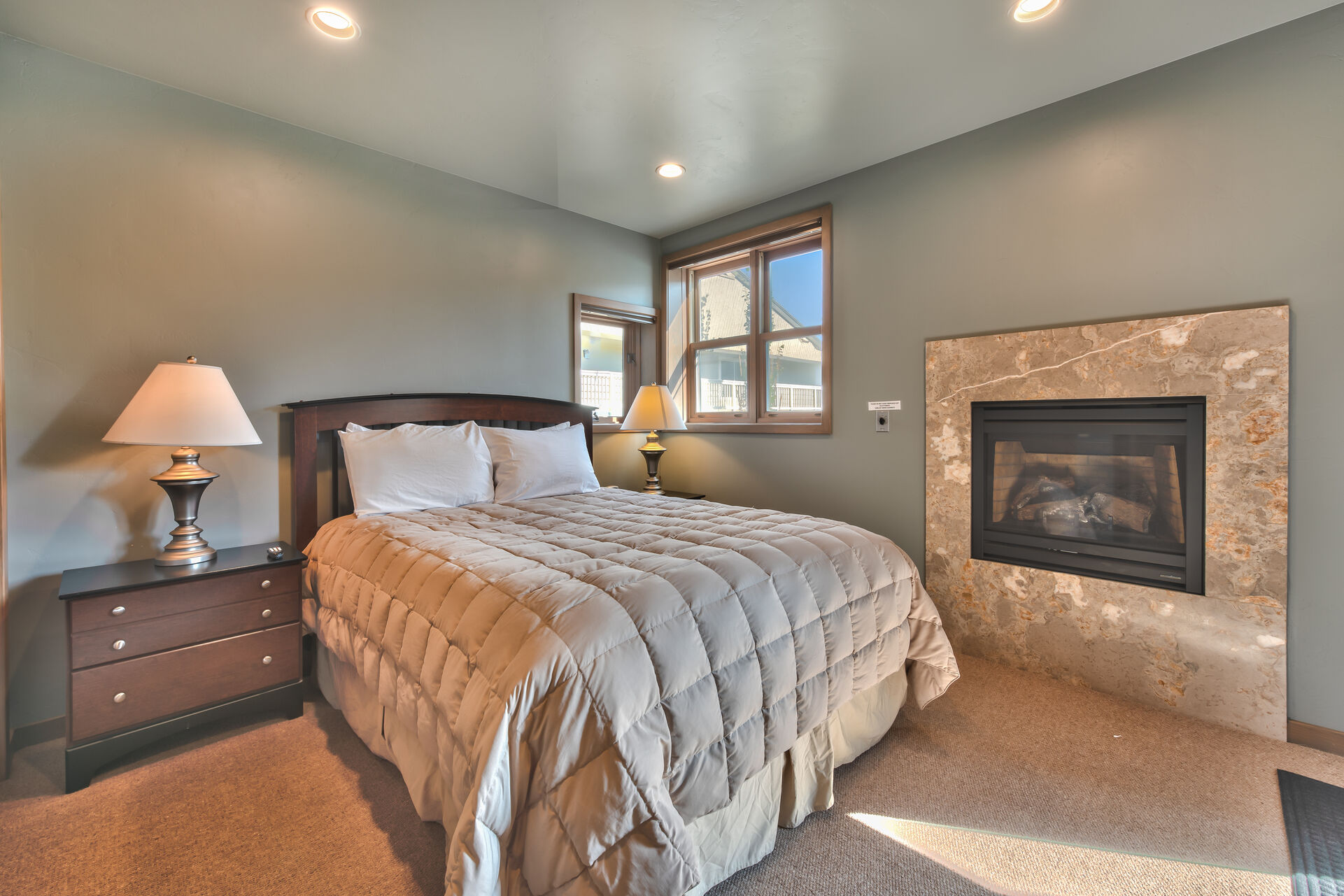 Level 1 - 2nd Master Bedroom with a Queen Bed, Radiant Heat, a Gas Fireplace, Private Bath and Backyard Access