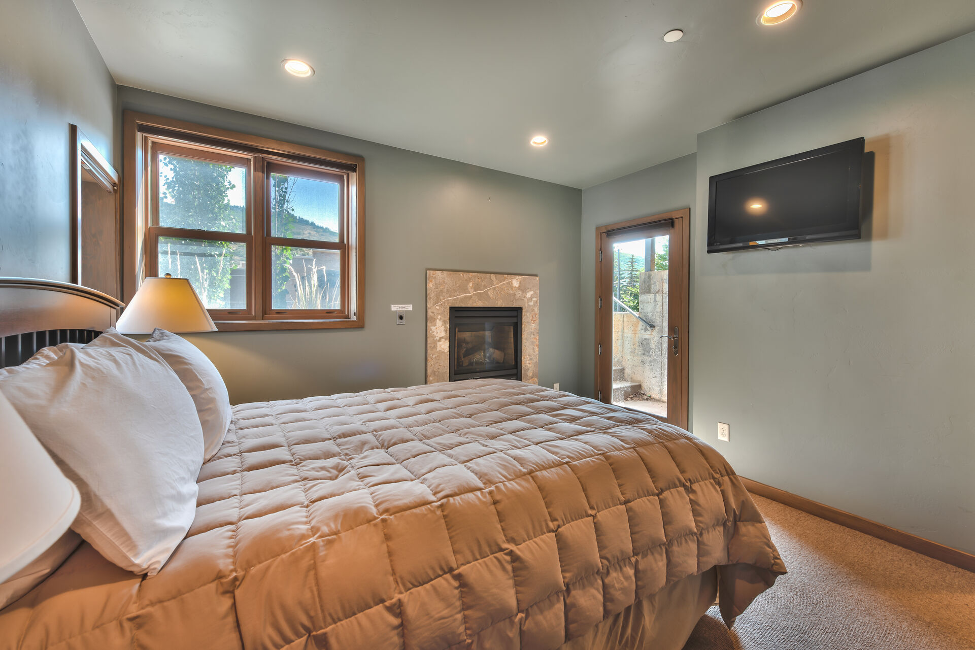 Level 1 - 2nd Master Bedroom with a Queen Bed, Radiant Heat, a Gas Fireplace, Private Bath and Backyard Access