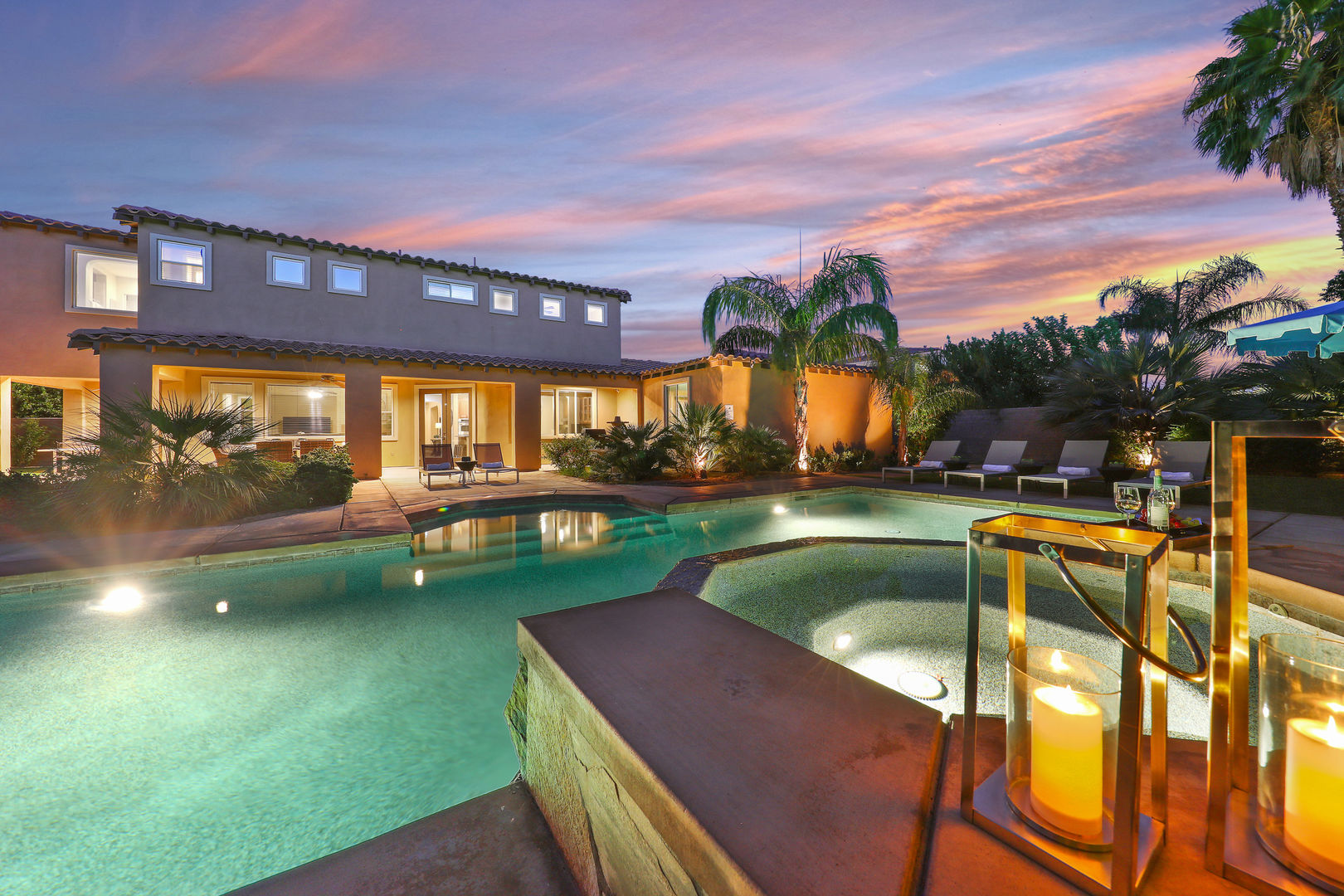 Spacious backyard with chaise lounge seating, oversized pool, spa, al fresco dining and basketball court