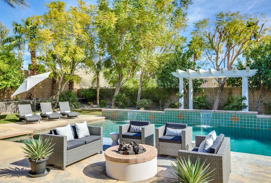 Comfortable chaise lounging poolside with 3 pool waterfalls