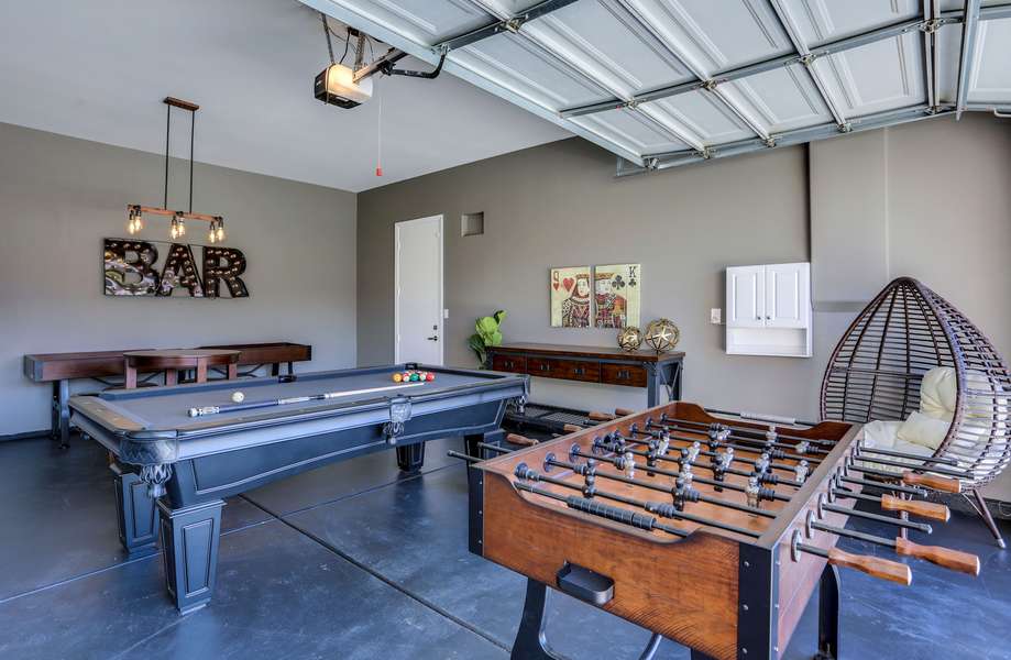 Game room with pool table, ping pong, foosball, shuffle board and game table w/seating