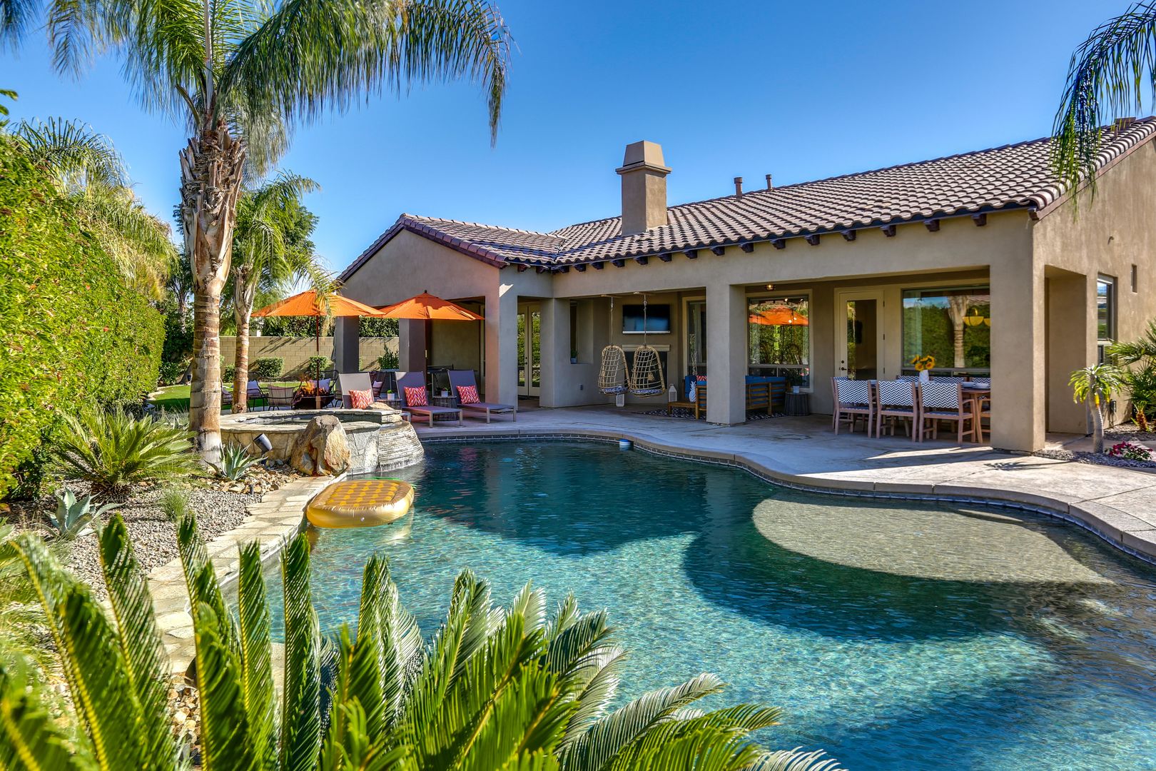 Private backyard with large pool and spa, fire pit, lounge seating, 2 fireplaces, 7-hole putting green, corn hole, ping pong, al fresco dining and more!