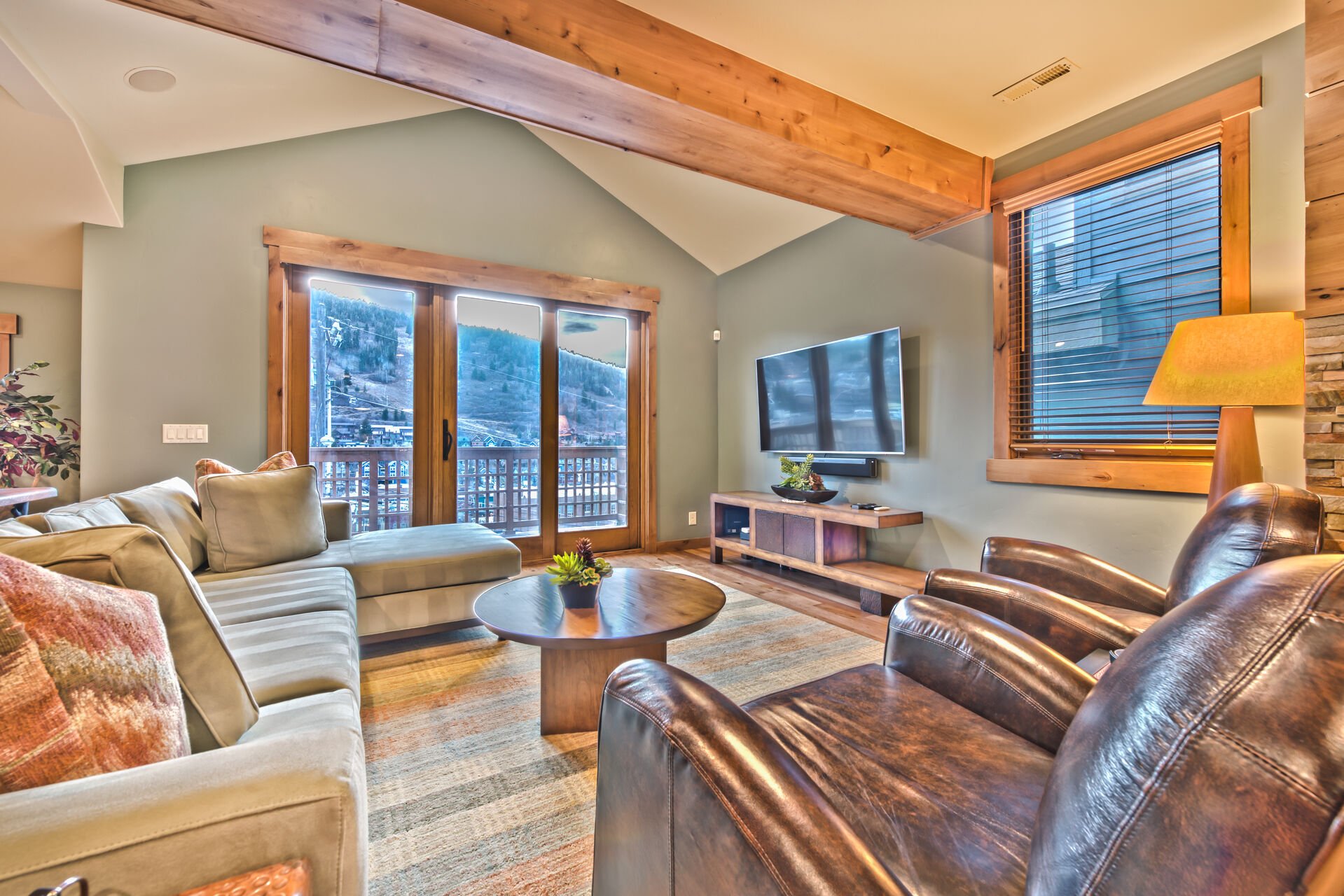 Living Room with Comfortable Mountain Furnishings, TV and Private Deck with Stunning Views!
