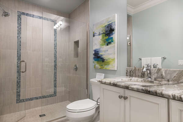 En-suite master bathroom with glass walk-in shower and dual vanity
