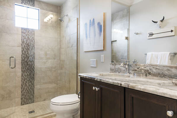 En-suite bathroom with glass walk-in shower and dual vanity