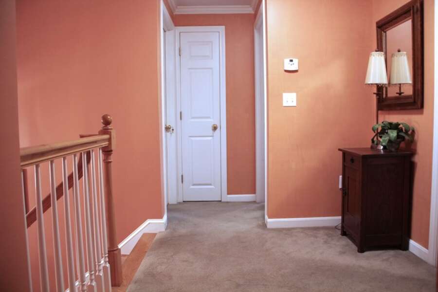 To the Left of the stairs is another bedroom and the full bath is in the middle-29 Ginger Plum Lane Harwich Port Cape Cod - New England Vacation Rentals