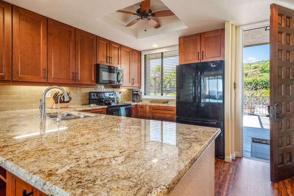 Fully Equipped Kitchen with Marble Counter Tops and Wooden Cabinets