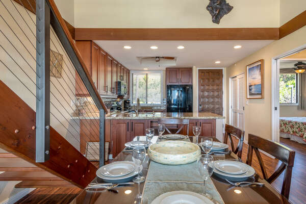 Dining Room and Kitchen Next to Wooden Staircase at Kona Hawaii Vacation Rentals