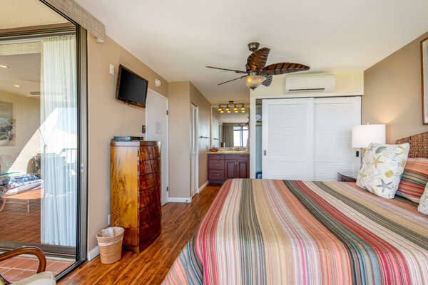 Primary Bedroom with TV Large Fan and Patio Access at Country Club Villas 315