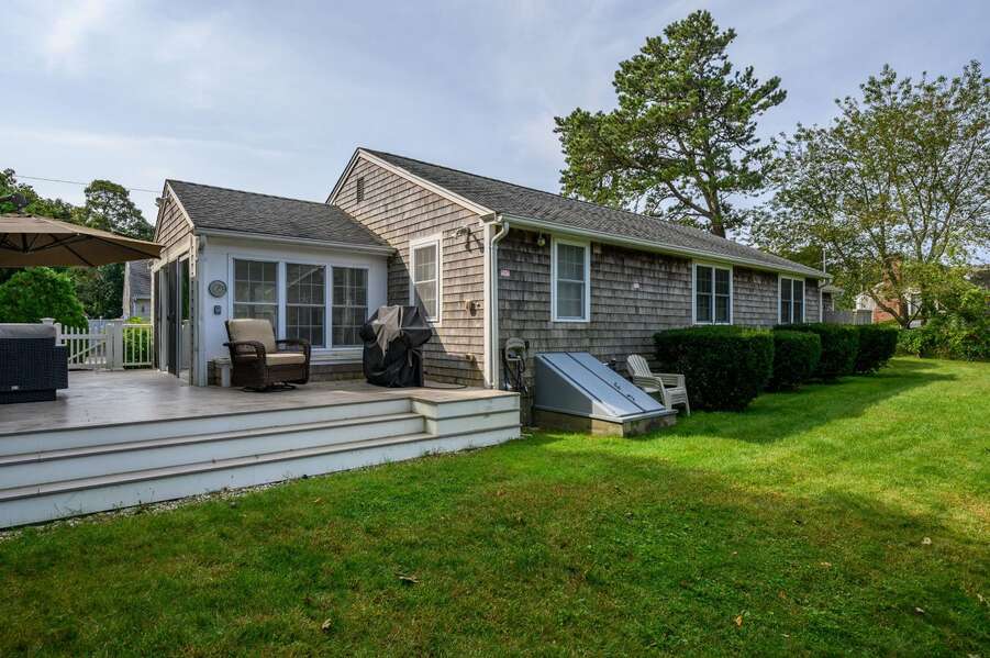 Back yard and deck into the house-  19 Burton Avenue West Harwich -  Lobsta House- New England Vacation Rentals